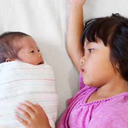 Young child with new baby sibling